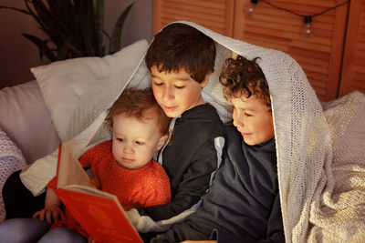 Cute real siblings reading the book 