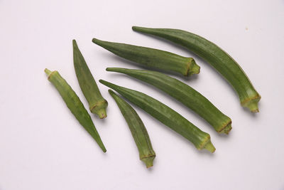 High angle view of green chili pepper against white background