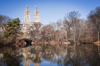 Reflection of trees and buildings in lake