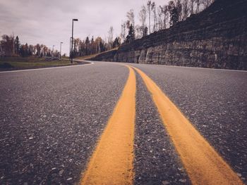 Surface level of empty road along trees