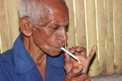 Close-up portrait of man smoking cigarette