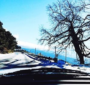 Road passing through snow covered landscape