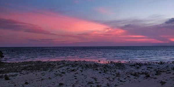 Scenic view of sea against romantic sky at sunset