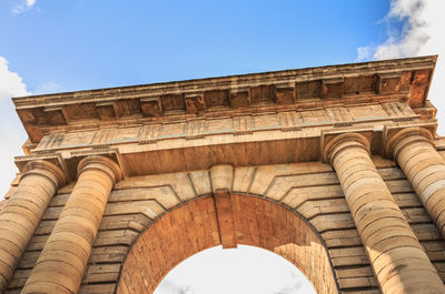 Low angle view of historical building against blue sky