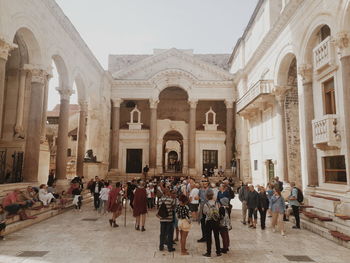 Group of people in front of historic building