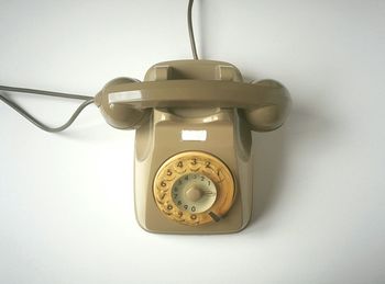 Close-up of telephone booth on table against white background
