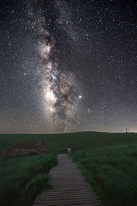 Scenic view of field against sky at night