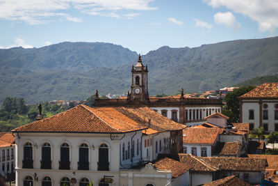 Buildings in town against sky