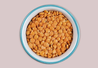 Directly above shot of green peas in bowl on white background