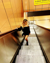 High angle view of woman standing on staircase