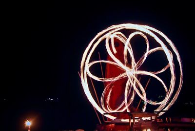 Low angle view of illuminated lights against sky at night