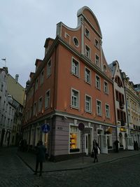 People walking on street in front of old town