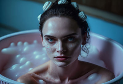 Close-up of young woman in bathtub