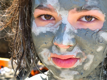 Close-up portrait of girl with facial mask on face