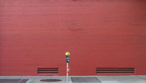 Red umbrella on brick wall