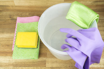 High angle view of cleaning equipment on wooden table