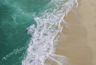High angle view of waves on beach