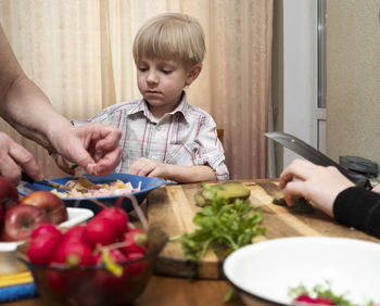 High angle view of woman holding food on table