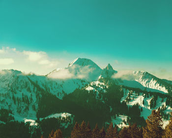 Scenic view of mountains against blue sky