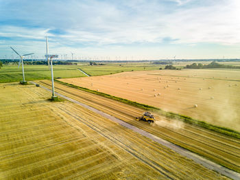 Aerial view of combine harvester harvesting at farm