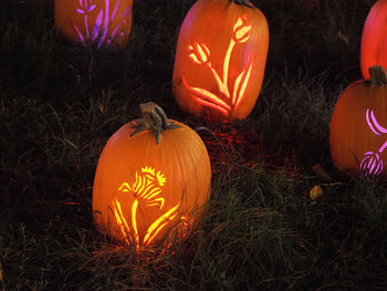 Illuminated pumpkin on field at night