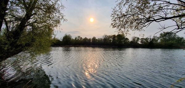 Scenic view of lake against sky during sunset