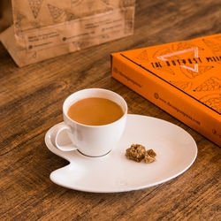 High angle view of coffee and cup on table