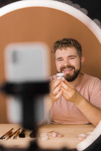 Young man using mobile phone in cafe