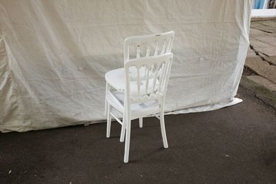 High angle view of white wooden chairs against canvas