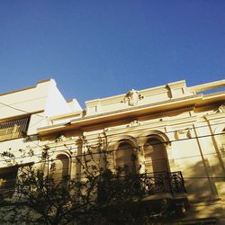 Low angle view of built structure against clear blue sky