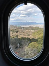 Scenic view of landscape seen through window