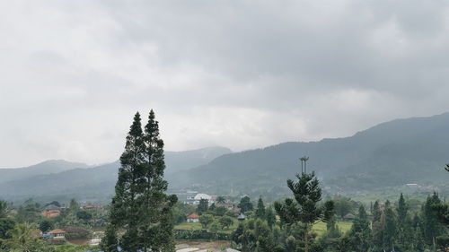 Scenic view of mountains against cloudy sky