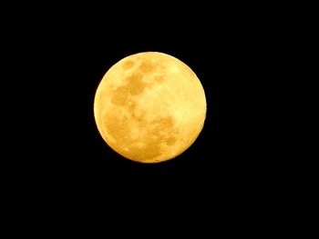 Low angle view of moon against clear sky at night