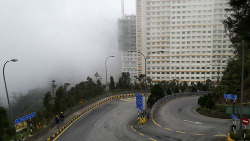 Panoramic view of city street in foggy weather