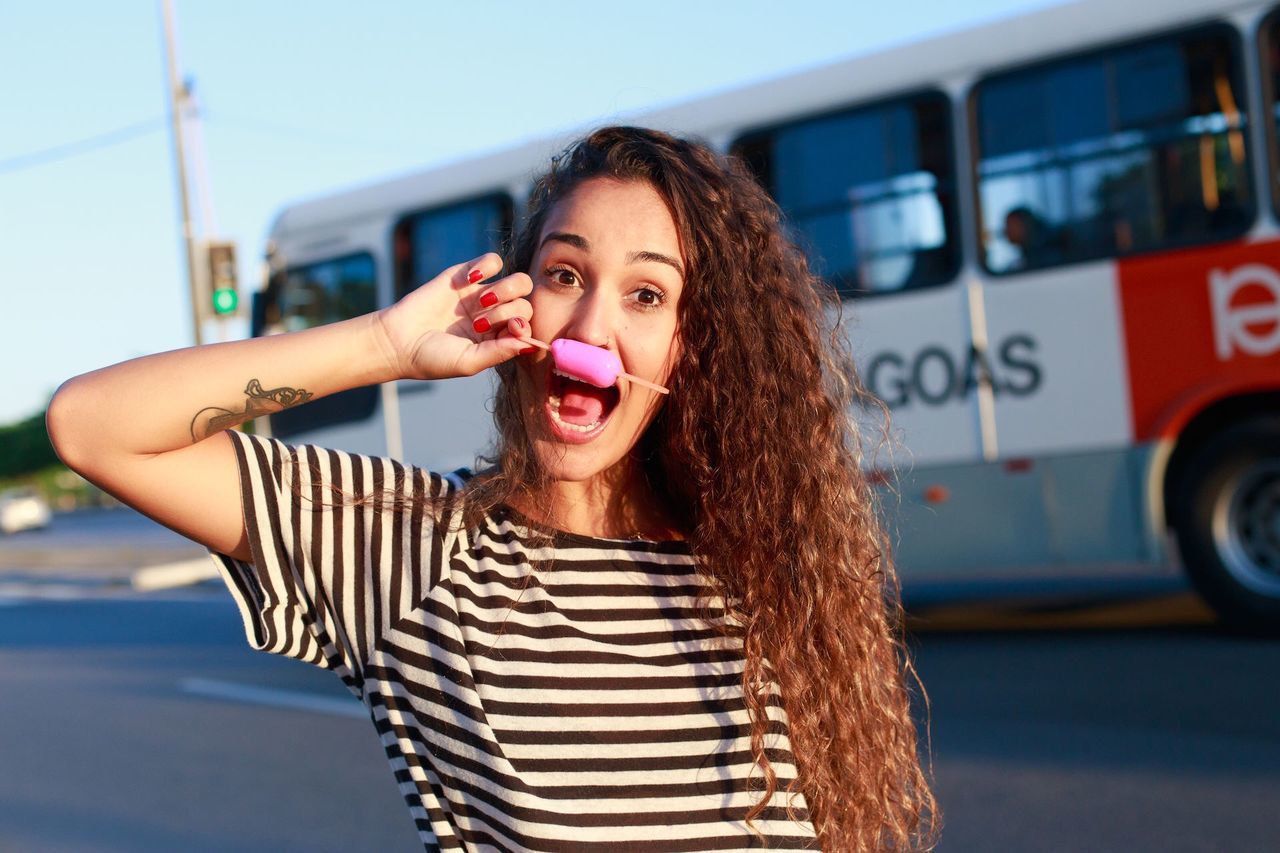 person, portrait, looking at camera, young adult, front view, smiling, young women, lifestyles, casual clothing, happiness, long hair, leisure activity, waist up, sunglasses, toothy smile, focus on foreground, blond hair