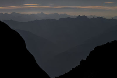 Scenic view of silhouette mountains against sky during sunset