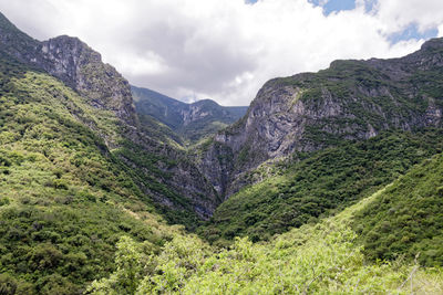 Scenic view of mountains against cloudy sky