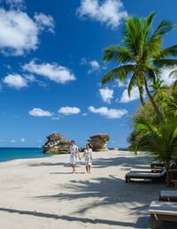 People on beach against sky