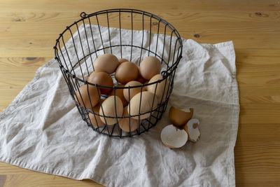 High angle view of eggs in basket on table