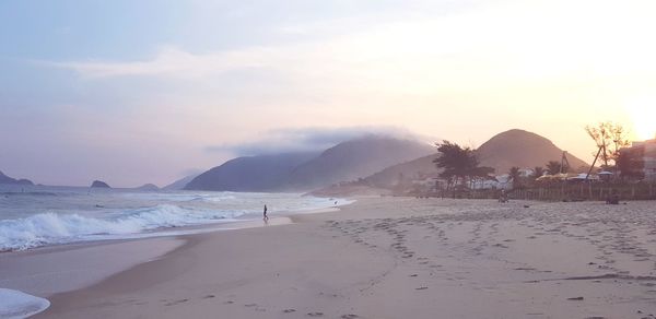 Scenic view of beach against sky during sunset