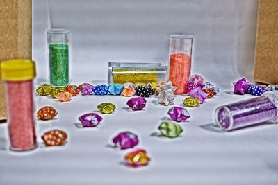 Close-up of multi colored glass on table