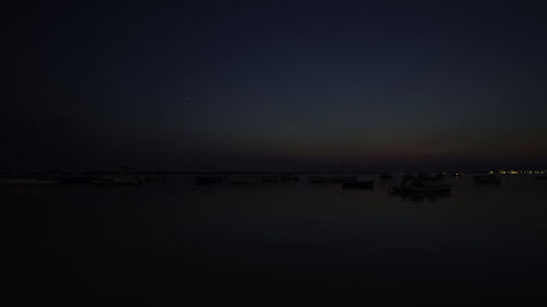 Scenic view of sea against clear sky at night