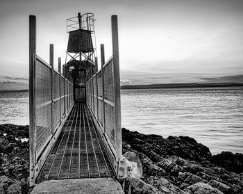 Pier over sea against sky