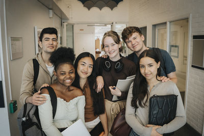 Portrait of happy multiracial students at university