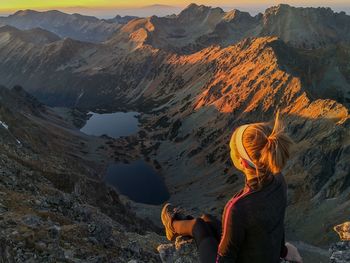 Rear view of woman looking at mountain range