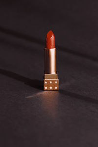 Close-up of red lipstick on table