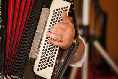 Close-up of man playing accordion