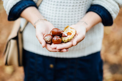 Close-up of woman holding fruit