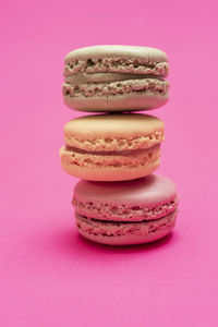 Close-up of cookies against pink background