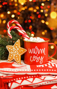 Merry christmas greeting card. hot chocolate infront xmas tree.